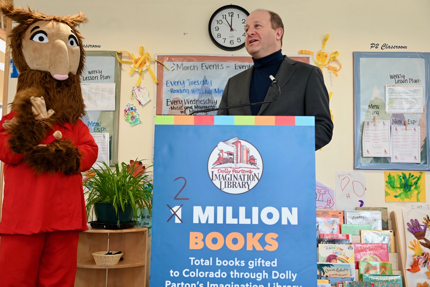 Governor Polis speaks at podium at Imagination Library event