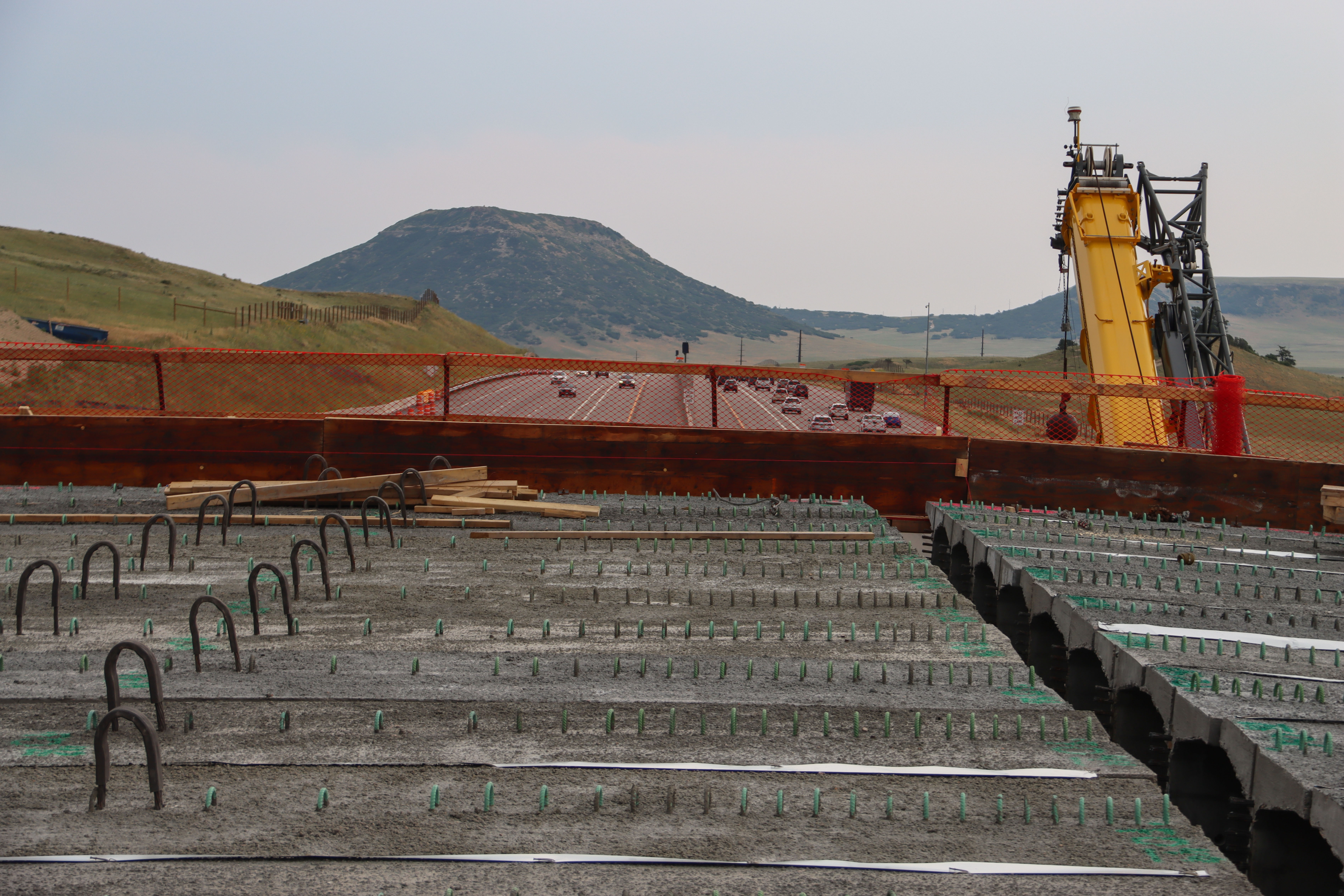 Photo of construction underway on Greenland Wildlife Overpass above I-25
