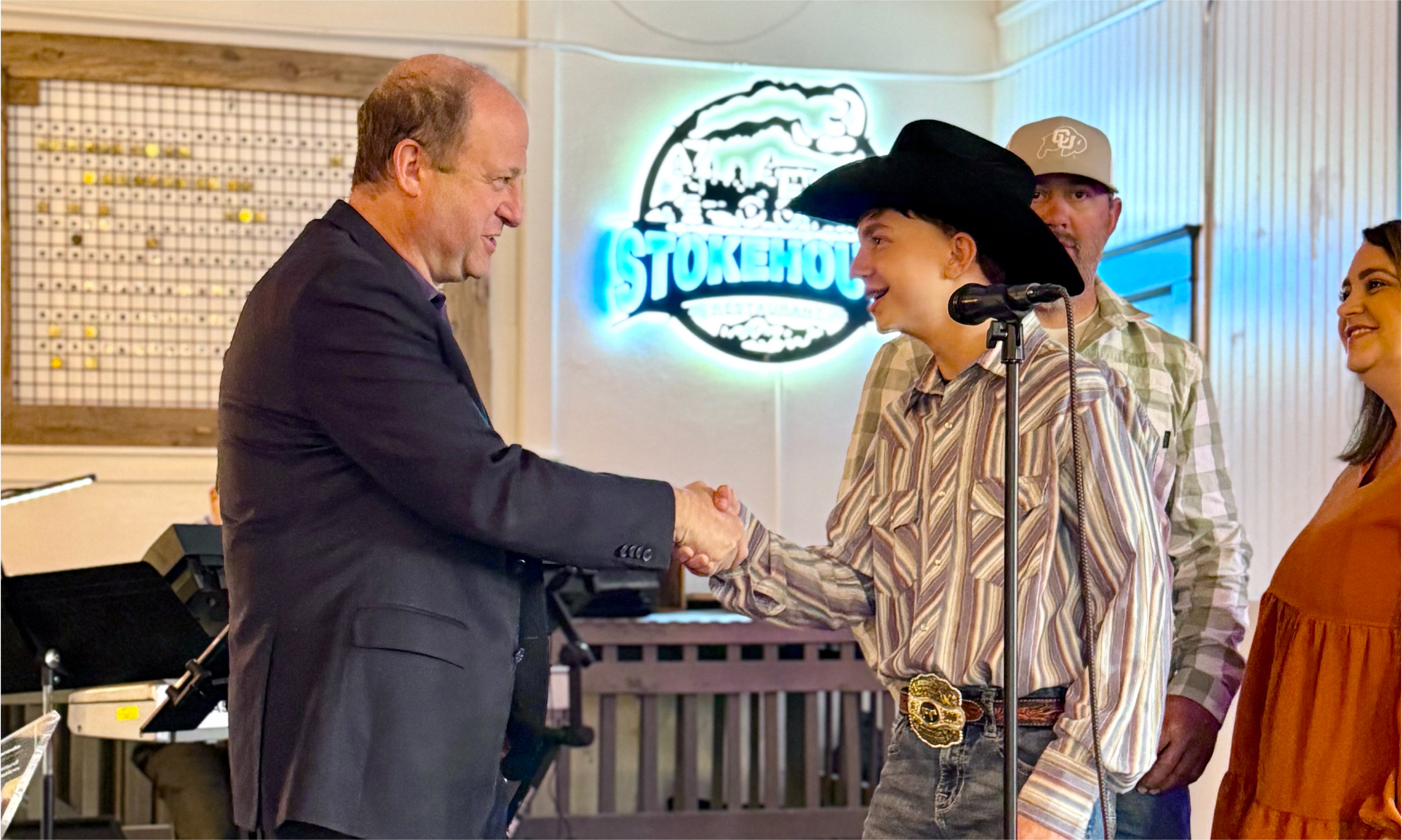 Governor Polis congratulates a member of the Andreatta Family for Walsenburg Mercantile being selected as a Stephen Hart Award winner  