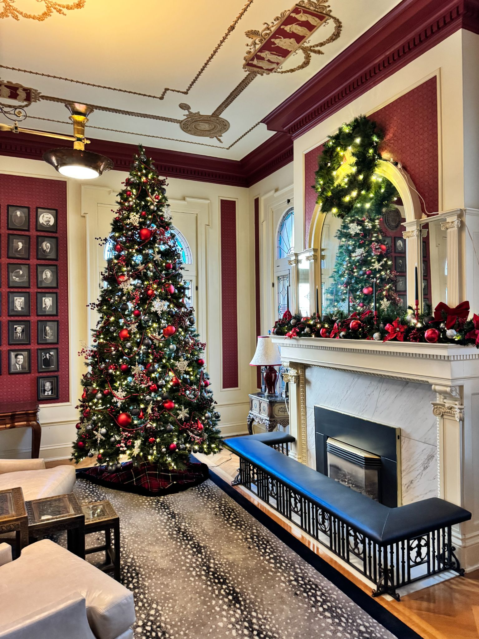 A christmas tree decorated in red in the bar of the Governor's mansion. 
