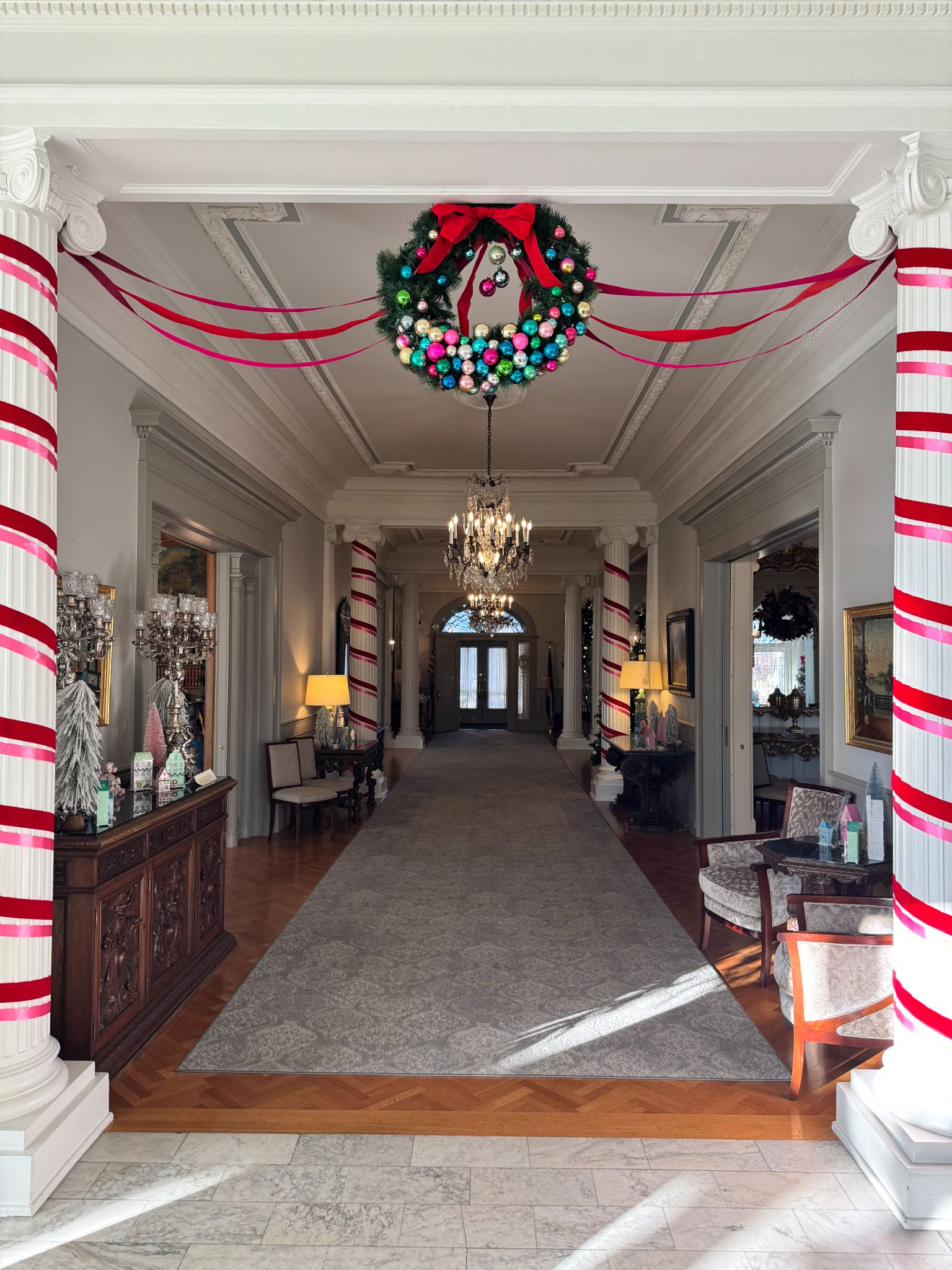 The main hallway of the Governor's mansion where the four pillars are wrapped in ribbon.