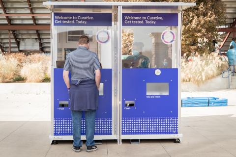 Man standing in front of testing kiosk.