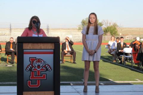 La Junta High School student Alyssa Bullock on stage next to the podium.