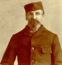 An archival photo of Alfred Packer in a hat and jacket